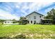 View of the backyard showing the two-story house with a pool and outbuildings at 4510 Cindy Rd, Lakeland, FL 33810