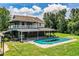Spacious backyard with a covered patio and a large inground pool, perfect for outdoor entertaining and relaxation at 4510 Cindy Rd, Lakeland, FL 33810