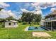 An inground pool in the backyard with a small shed and the side of the main house at 4510 Cindy Rd, Lakeland, FL 33810