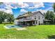 Rear exterior view of the home showcasing the expansive backyard, pool, and covered patio at 4510 Cindy Rd, Lakeland, FL 33810