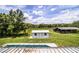 View of backyard buildings and sheds with pool cover at 4510 Cindy Rd, Lakeland, FL 33810