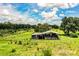 Functional barn with stalls, perfect for equestrian or agricultural use, set in a serene green pasture at 4510 Cindy Rd, Lakeland, FL 33810