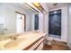 Bathroom featuring marble counter tops, tile shower and wood-look flooring at 4510 Cindy Rd, Lakeland, FL 33810