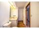 Bathroom featuring marble countertops and wood-look flooring and large mirror at 4510 Cindy Rd, Lakeland, FL 33810