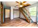 Bedroom with a wooden staircase, a ceiling fan, and wood-look floors at 4510 Cindy Rd, Lakeland, FL 33810