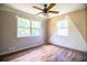 Empty bedroom with two windows and light wood-look floors and ceiling fan at 4510 Cindy Rd, Lakeland, FL 33810