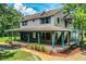 Inviting two-story home with a wrap-around porch, offering a blend of classic charm and serene outdoor living at 4510 Cindy Rd, Lakeland, FL 33810
