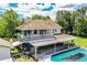Two-story home with a covered pool deck and a second-story balcony overlooking a well-maintained backyard at 4510 Cindy Rd, Lakeland, FL 33810