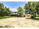 Two-story home with a large front porch and a detached two-car garage, all nestled within a spacious yard at 4510 Cindy Rd, Lakeland, FL 33810