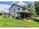 Classic two-story home featuring a generous front porch with a sprawling lawn and mature trees surrounding the property at 4510 Cindy Rd, Lakeland, FL 33810