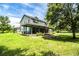 Charming two-story home with a spacious wrap-around porch and lush green lawn at 4510 Cindy Rd, Lakeland, FL 33810