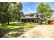 Charming two-story home with a covered front porch and mature trees in a lush green yard at 4510 Cindy Rd, Lakeland, FL 33810