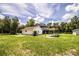 Spacious yard featuring a two-story house and an outbuilding on a sunny day at 4510 Cindy Rd, Lakeland, FL 33810