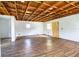 Garage interior with wood beam ceiling and plank flooring at 4510 Cindy Rd, Lakeland, FL 33810