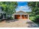 View of detached garage with painted doors and concrete driveway at 4510 Cindy Rd, Lakeland, FL 33810