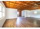 Garage interior featuring wood beam ceiling and plank flooring at 4510 Cindy Rd, Lakeland, FL 33810