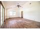 Bright living room with high ceiling, wood floors, ceiling fan, and backyard access at 4510 Cindy Rd, Lakeland, FL 33810