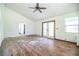 Bright living room with wood floors, ceiling fan, and door to the backyard at 4510 Cindy Rd, Lakeland, FL 33810
