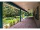 A long, covered porch allows enjoyment of the landscaped yard at 4510 Cindy Rd, Lakeland, FL 33810