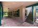 Covered porch with brick floors and stairs to another level at 4510 Cindy Rd, Lakeland, FL 33810