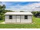Exterior shot of the shed featuring light gray siding and a single door entrance at 4510 Cindy Rd, Lakeland, FL 33810