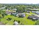 Aerial view of a well-maintained suburban home surrounded by lush greenery and neighboring houses at 4908 Celia W Cir, Lakeland, FL 33813