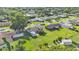 Aerial view of a suburban home surrounded by lush greenery and neighboring houses at 4908 Celia W Cir, Lakeland, FL 33813