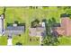 Aerial view of a suburban home with a well-maintained lawn, a driveway, and manicured landscaping at 4908 Celia W Cir, Lakeland, FL 33813