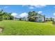 Large, grassy backyard with mature trees and a shed at 4908 Celia W Cir, Lakeland, FL 33813