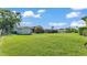 Spacious backyard featuring lush green grass and a shed on the property at 4908 Celia W Cir, Lakeland, FL 33813