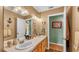 Well-lit bathroom features a double vanity, neutral colors, and updated fixtures at 4908 Celia W Cir, Lakeland, FL 33813