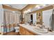 Bright bathroom with double vanity, tan walls, and walk-in shower at 4908 Celia W Cir, Lakeland, FL 33813