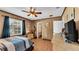 Comfortable bedroom features a ceiling fan, natural light, and ample dresser space at 4908 Celia W Cir, Lakeland, FL 33813