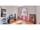 Bright bedroom with wood floors, pink curtains, and colorful decor at 4908 Celia W Cir, Lakeland, FL 33813