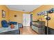 Bright bedroom features yellow walls, wood floors, and fun decor at 4908 Celia W Cir, Lakeland, FL 33813