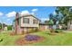 Spacious home with a brick chimney and a well-maintained lawn with garden beds at 4908 Celia W Cir, Lakeland, FL 33813