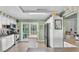 Bright kitchen with white cabinets, stainless appliances, an island, and a doorway to a green outdoor space at 4908 Celia W Cir, Lakeland, FL 33813