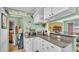 Bright kitchen featuring white cabinets, dark countertops, stainless toaster oven and view to dining room at 4908 Celia W Cir, Lakeland, FL 33813