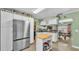 Bright kitchen featuring stainless steel appliances, white cabinets, an island, and a doorway to the dining room at 4908 Celia W Cir, Lakeland, FL 33813