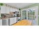 Kitchen with stainless steel appliances and a door to the outside; upper cabinets are decorated with a plate collection at 4908 Celia W Cir, Lakeland, FL 33813