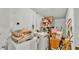 Laundry room with washer, dryer, storage shelves, and assorted household items at 4908 Celia W Cir, Lakeland, FL 33813