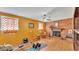Cozy living room with a brick fireplace, rocking chair, and home exercise equipment at 4908 Celia W Cir, Lakeland, FL 33813
