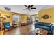 Bright living room featuring hardwood floors, ample seating, and natural light at 4908 Celia W Cir, Lakeland, FL 33813