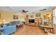 Cozy living room with hardwood floors, comfortable seating, and a ceiling fan at 4908 Celia W Cir, Lakeland, FL 33813