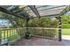Covered patio with wood pergola, fenced railing and a view of the lush backyard at 4908 Celia W Cir, Lakeland, FL 33813