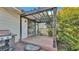 Back patio with a wood pergola and view into the backyard, ideal for outdoor relaxing at 4908 Celia W Cir, Lakeland, FL 33813