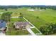 Aerial view of a single-Gathering home surrounded by a white fence and a large green lawn at 5370 Knights Station Rd, Lakeland, FL 33810