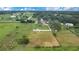 Aerial view of a single-Gathering home, set on a large lot with views of lakes, fields, and mature trees at 5370 Knights Station Rd, Lakeland, FL 33810