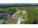 Aerial view of a single Gathering home with a fenced yard, surrounded by lush greenery and a serene pond at 5370 Knights Station Rd, Lakeland, FL 33810