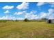Spacious green backyard features a large metal storage shed and open land beyond the fence at 5370 Knights Station Rd, Lakeland, FL 33810